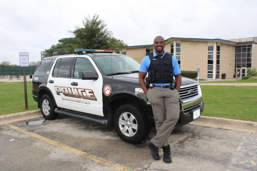 New school cop, Hakeem Smith, poses in front of his patrol car. Smiths goal is to form a positive relationship with all students. Photo by Camille Wodarz.