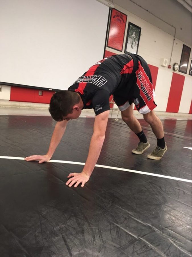 Sophomore Declan Smith demonstrates yoga position Downward Facing Dog. “Hot yoga has been super beneficial for my athletics,” Smith said, “it really helps improve flexibility and build core strength.” 