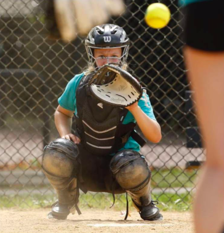 Waiting for the ball, Sophomore Tessa Peterson stands ready and in position to receive it. Since being assigned as a catcher in eighth grade, Tessa worked hard and maintained her title as catcher despite the inconveniences thrown her way. “I play on a travel team and so we were able to play all summer with some restrictions,” Peterson said, explaining how she still played in her position today.
Photo by Stacey Wescott