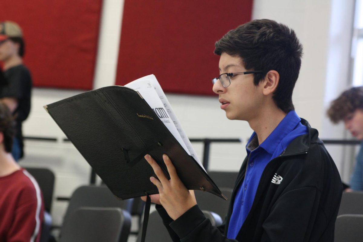Michael Vargas practices music for the upcoming Love Lights the Sky concert. The concert features acts from all five curricular choirs. Photo by Alana Zink, 27