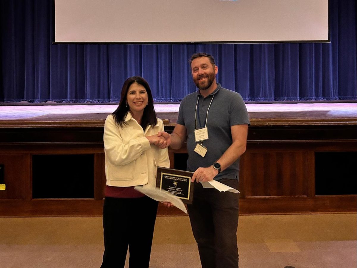 Feineis poses to accept the Physics Teacher of the Year award for this school year. Feineis has been teaching physics at BHS for 22 years. Photo courtesy of Shannon Feineis.