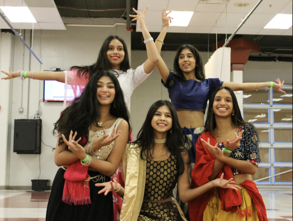 Emma Moorut ‘25, Riya Shah ‘25, Aarohi Chatterjee ‘26, Maya Moorut ‘26 and Deeksha Adhikary ‘27 pose after their performance for the Garba. The girls are part of the group “Dance Without Borders” that promotes styles of dancing native to the Indian subcontinent. Photo by Anika Shinde, ‘25