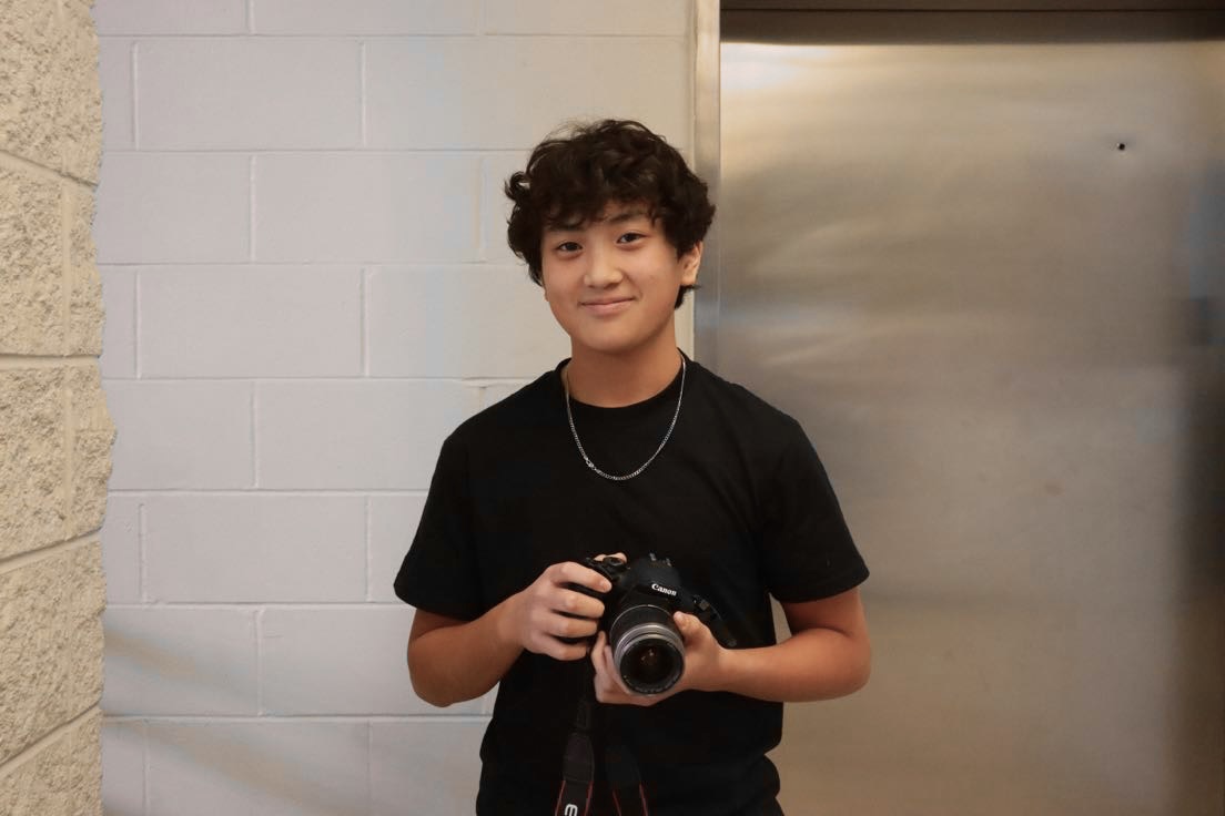 Freshman Weston Mui poses with the camera that he uses for filming. Mui has won several awards from his filmmaking hobby. Photo by Alexander Brudvik, 27.