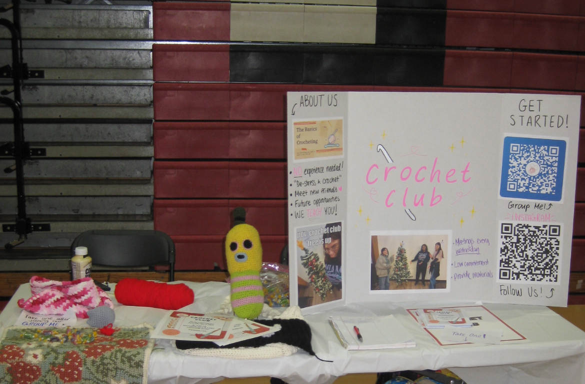 The Crochets Club showcases handmade projects and invite students to join via QR during the 2025 Activity Fair. Photo curtesy of Ellen Yoo, 26'