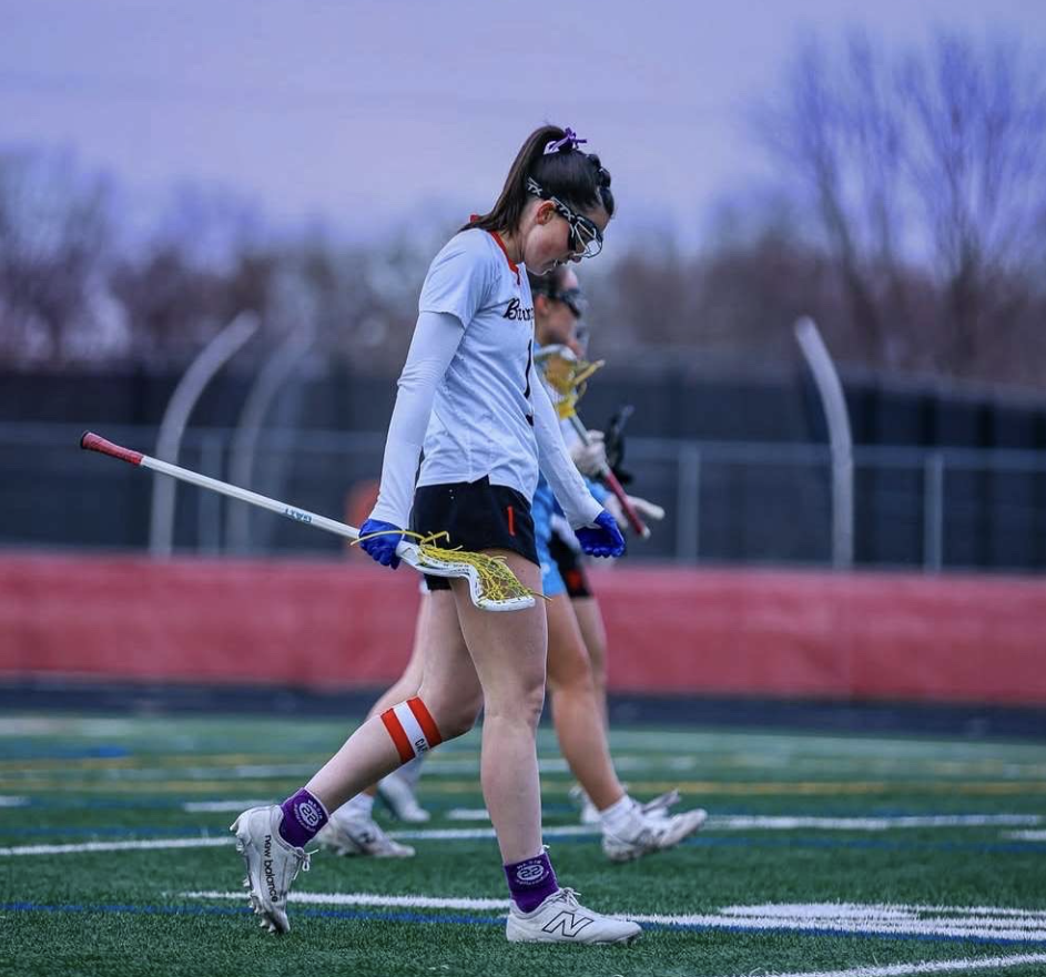 Senior Emma Menke walks down the field after victory. Menke played at home against Hersey, and her' team secured a 16-4 victory. Photo provided by Emma Menke.
