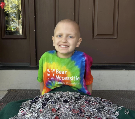 Tommy Fennig sitting by the 16lbs of pop tabs collected for RMHC. Photo provided by Vanessa Fennig.