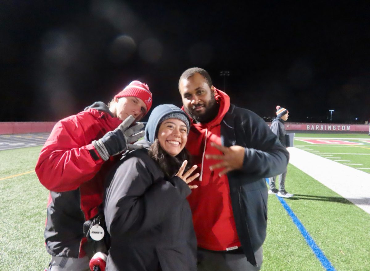 Athletic trainers Russ Schellhase, and Tone Shinaul, Jennifer Quintas pose at a football game. They attended the Barrington game during the season. Photo courtesy of Jennifer Quintas.